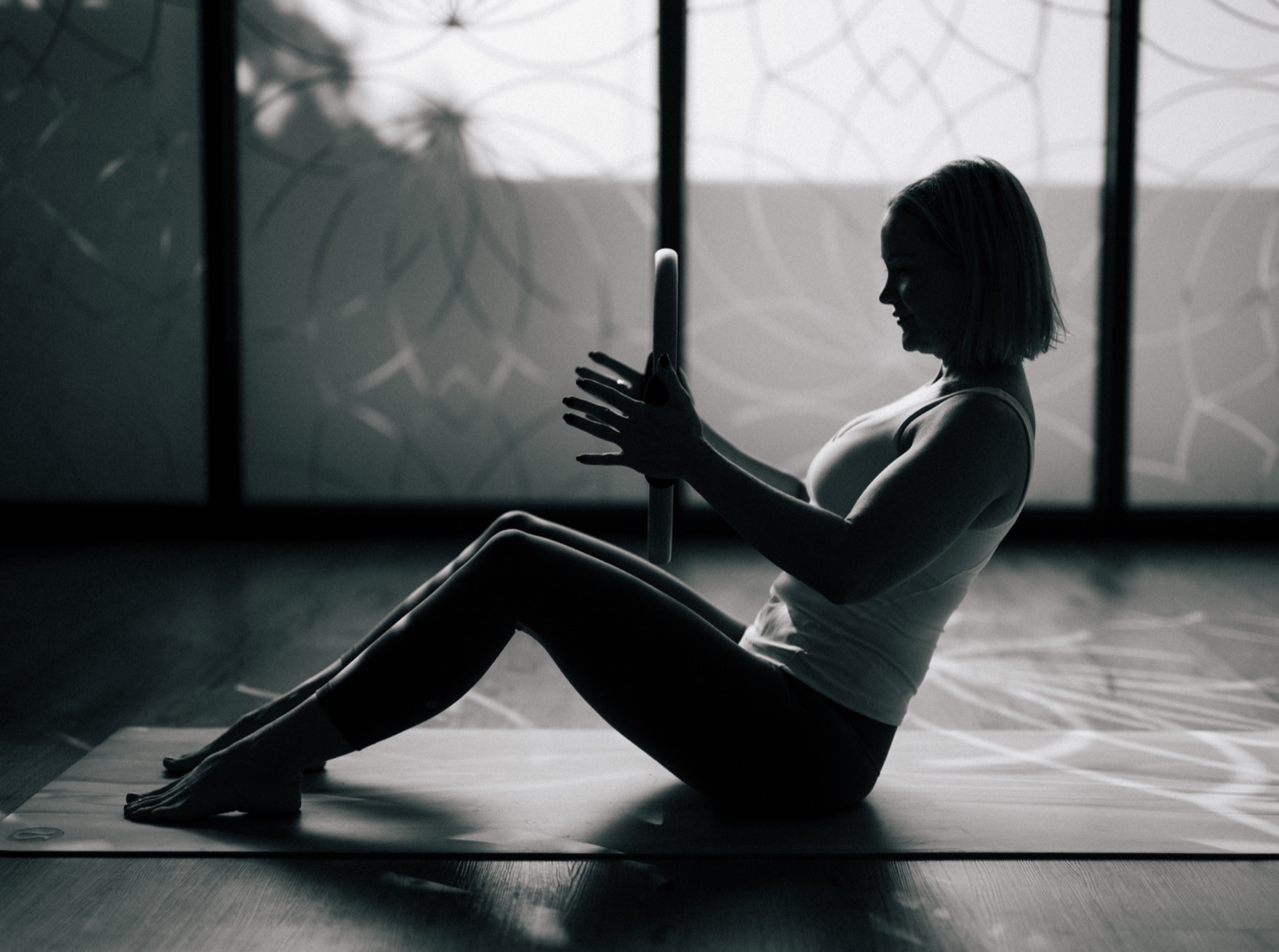 A woman practising Pilates in a studio
